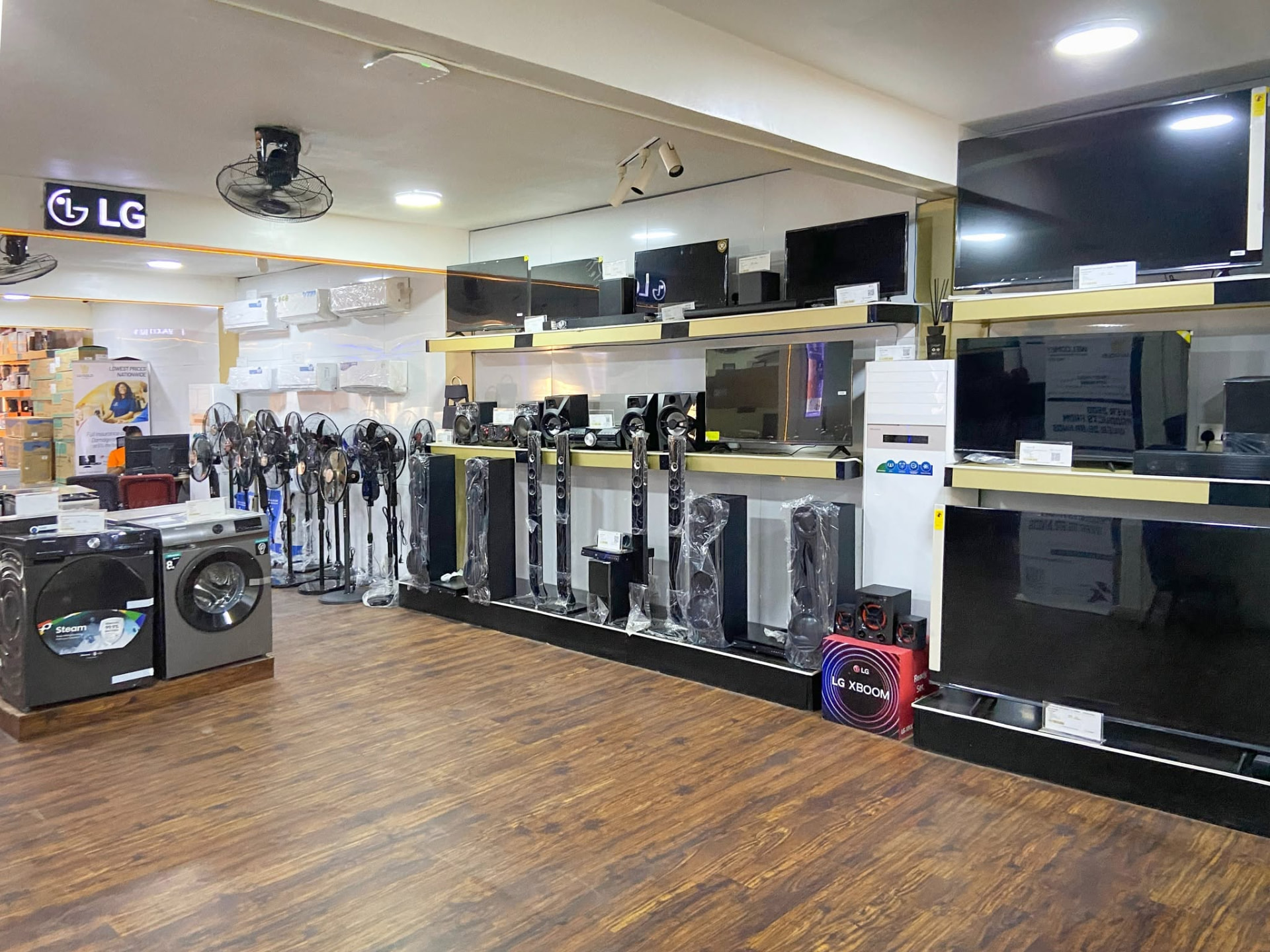 Lu Gold Store showroom wall of flat-screen televisions, sound systems and appliances